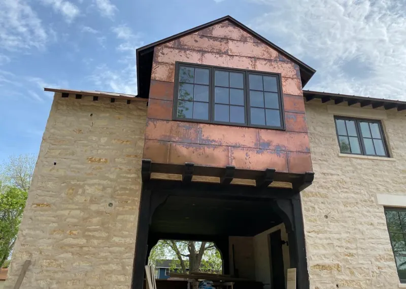 Copper metal panel facade on a stone building for Skylight Installation in Fairport